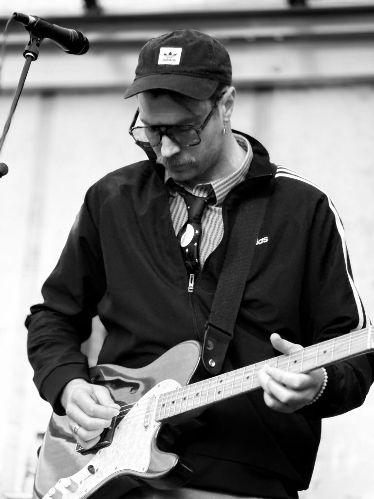 Stan fronting with guitar
